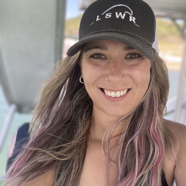Kayla Remillard, Operations Manager at Keep Austin Wet, on a boat on Lake Travis with her dog Harlow