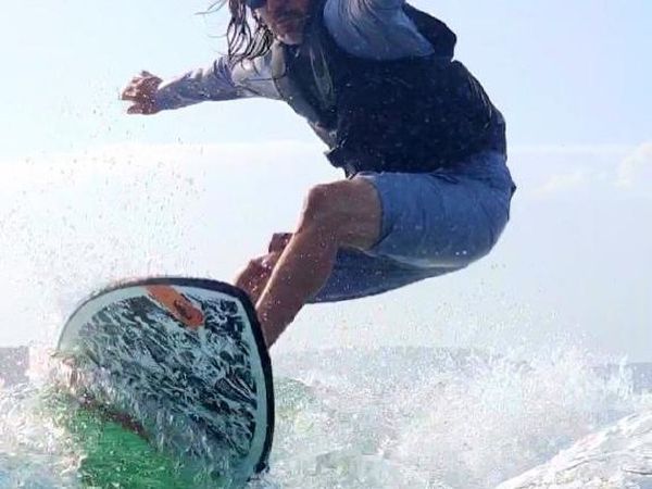 Santos Ramirez wakesurfing on Lake Travis - Keep Austin Wet founder