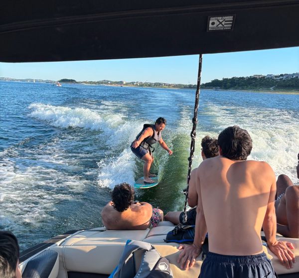 Wakesurf rider catching the wave on Lake Travis - Keep Austin Wet